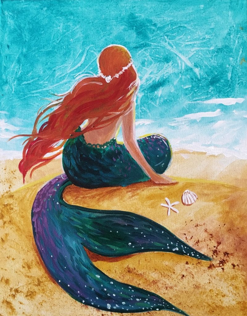 Mermaid sun bathing with ocean and sea shells